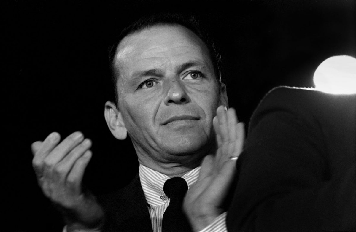 Une photo en noir et blanc de Frank Sinatra frappant dans ses mains.