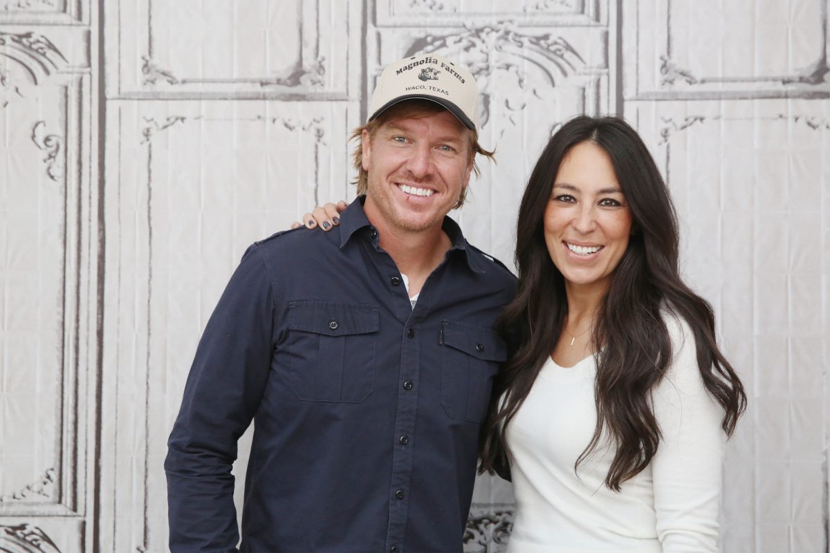 Chip et Joanna Gaines sourient lors d'un événement AOL, Chip portant une chemise et un chapeau foncés et Joanna portant un haut blanc.