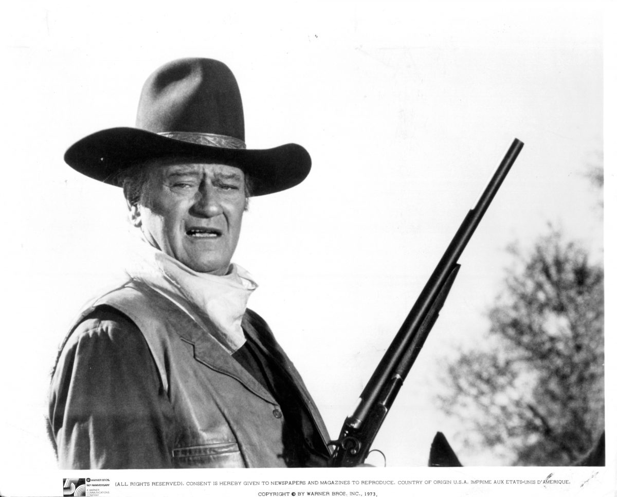 'The Conqueror' acteur John Wayne tenant une arme à feu