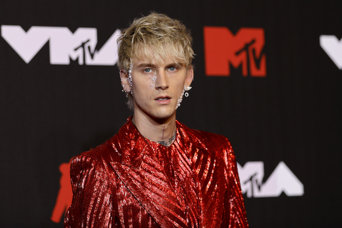 Machine Gun Kelly devant un fond noir