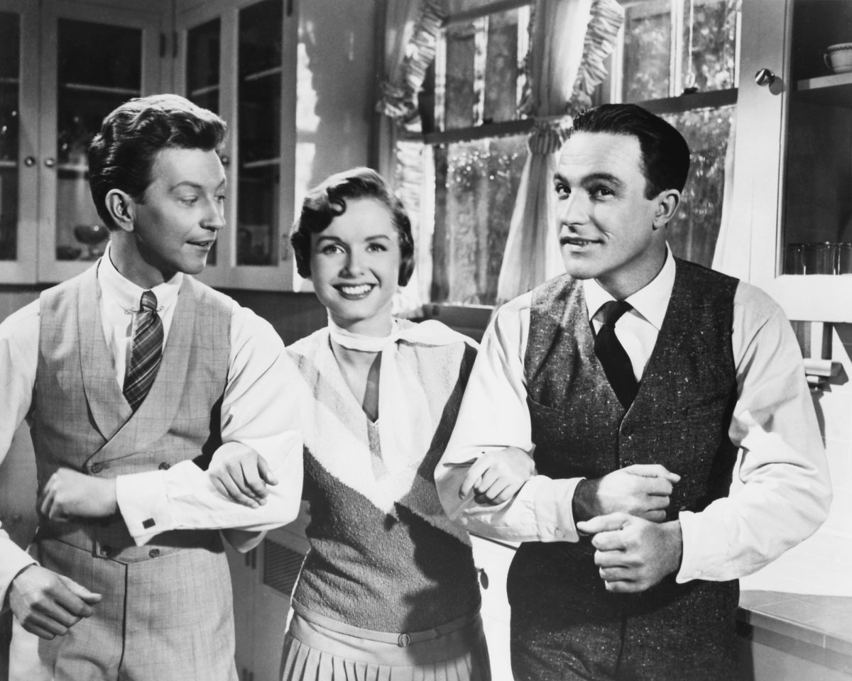 'Singin' in the Rain' Donald O'Connor dans le rôle de Cosmo Brown, Debbie Reynolds dans le rôle de Kathy Selden et Gene Kelly dans le rôle de Don Lockwood pendant la séquence de 'Good Morning' souriant et liant les bras