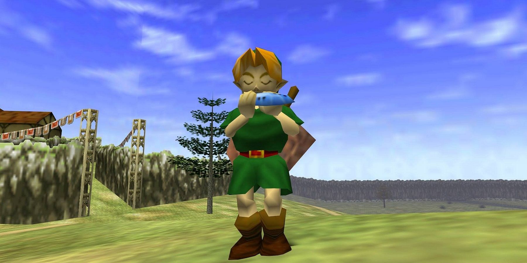 Image de The Legend of Zelda: Ocarina of Time montrant Link jouant l'ocarina titulaire dans un champ.