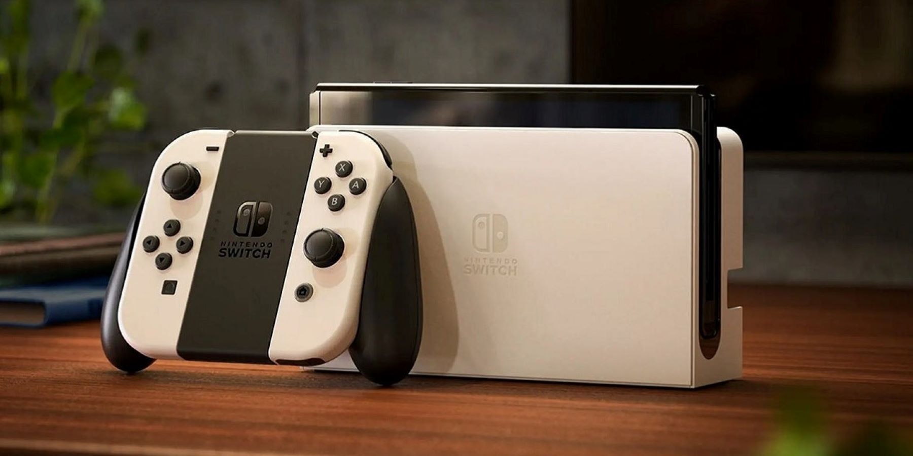 Un Nintendo Switch OLED blanc avec Joy-Cons retiré assis sur une table